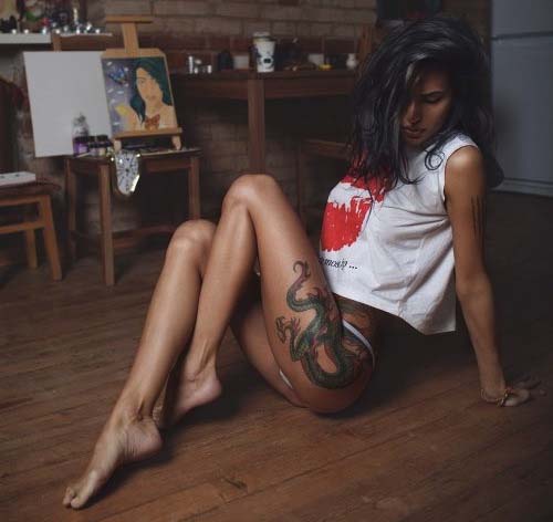 Leggy tattooed brunette babe